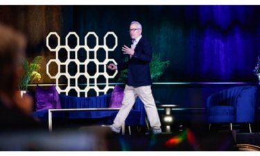 Man walking on a stage during conference